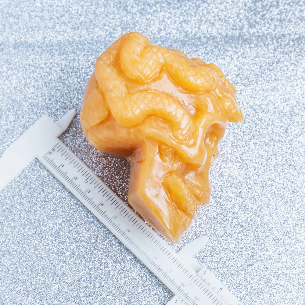 Wholesale natural high quality hand carved orange calcite crystal skulls folk carfts with snake for Halloween decoration
