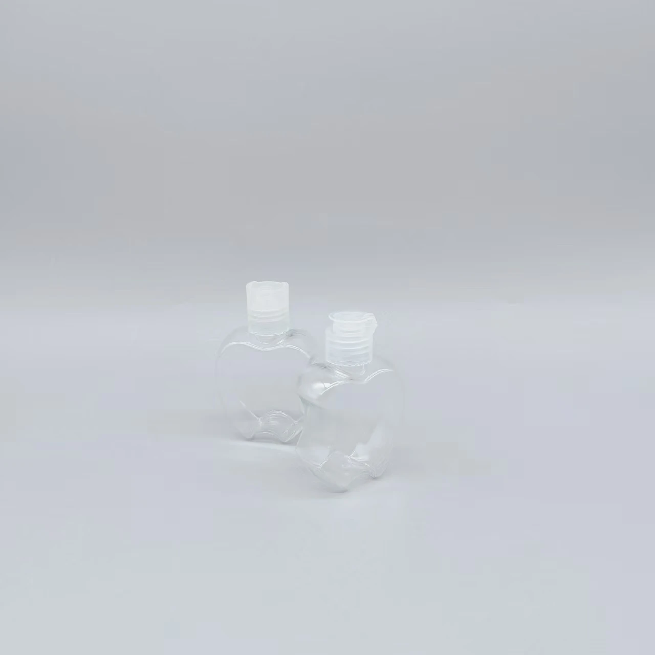 60ml apple transparent spray bottle manufacturers produce PET perfume plastic spray bottle can be processed to do color