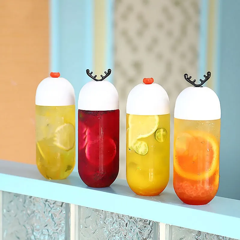 Hot Selling Capsule Shape Beverage Bottle Personalized Antler Stopper Transparent Plastic Bottle Creative Juice Bottle