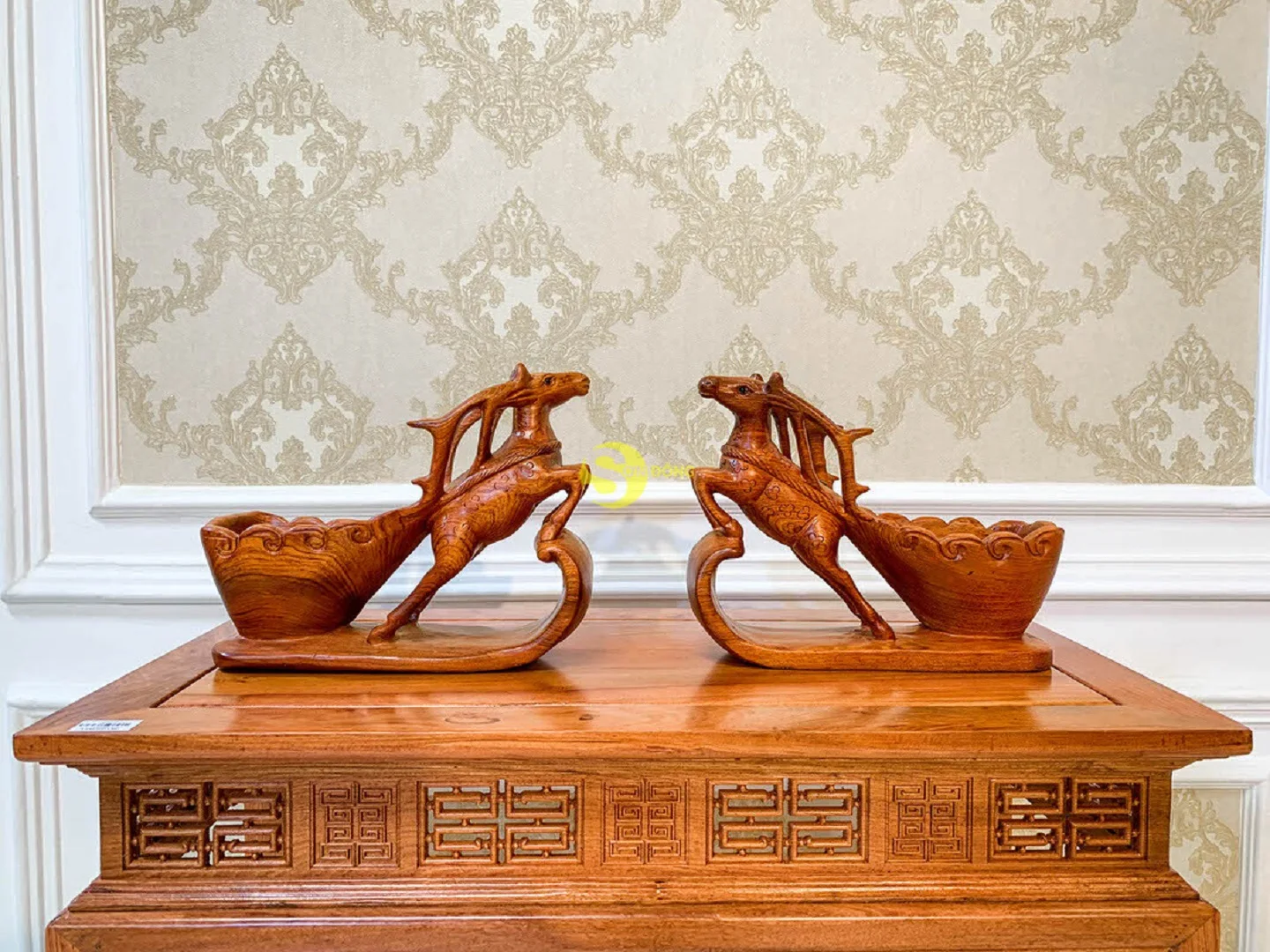 Reindeer pull cart carrying bottles of wine