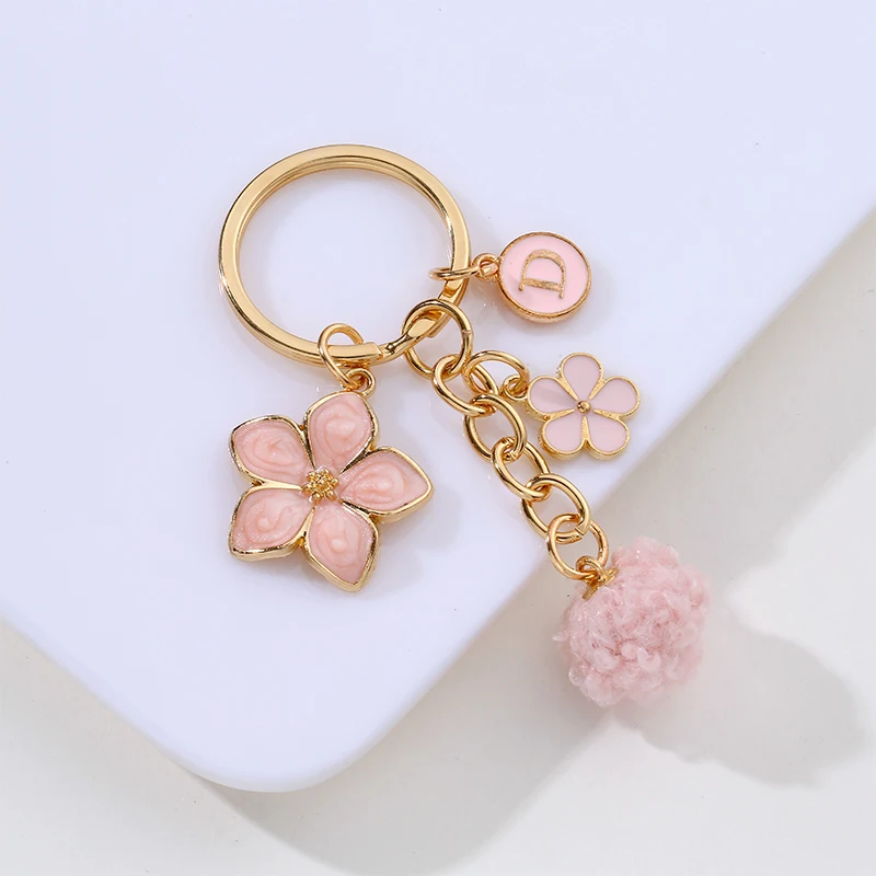 New personalized flower letter hairball Keychain phone case pendant small fresh simple headphone cover bag decoration