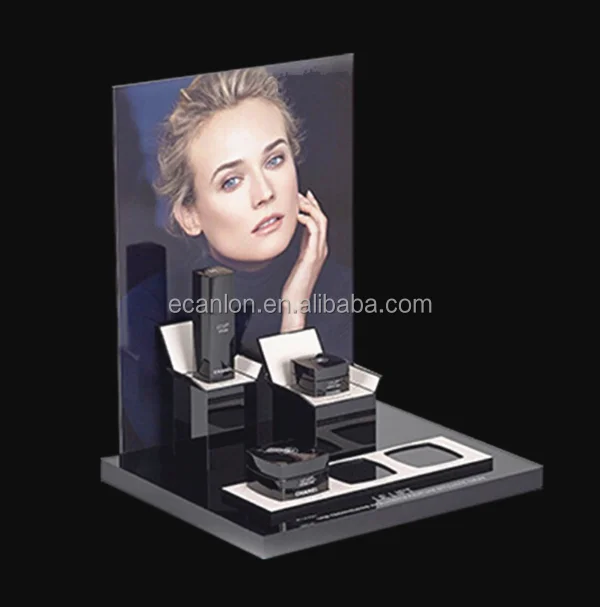 Custom black acrylic desktop cosmetics display stand with clear blocks on it and poster holder