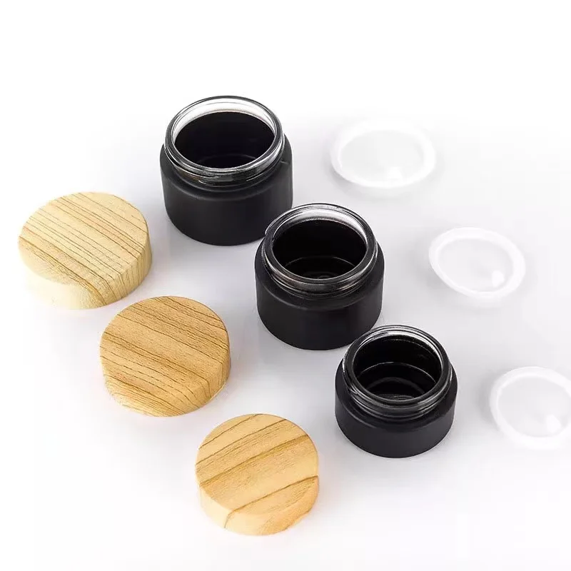 5g 10g 15g 20g 30g 50g 100g wholesale black bottle cosmetic packaging glass cream jars with bamboo plastic wood grain lid