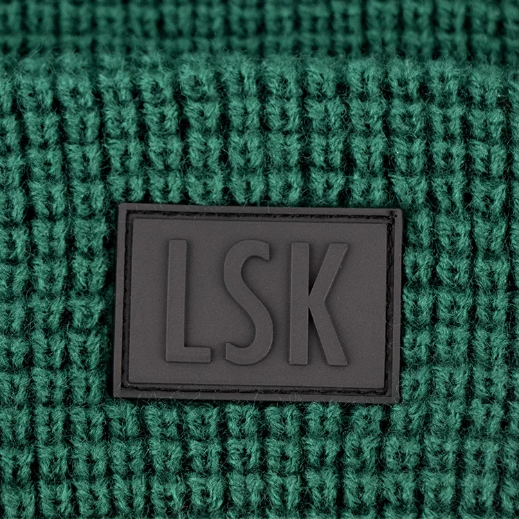 Hengxing solid green color custom pvc rubber patch skull cap soft cuffed winter warm hat waffle knit beanie manufacturer