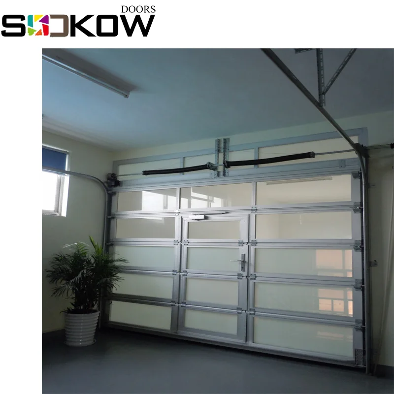 glass sectional door with pesdestrain door