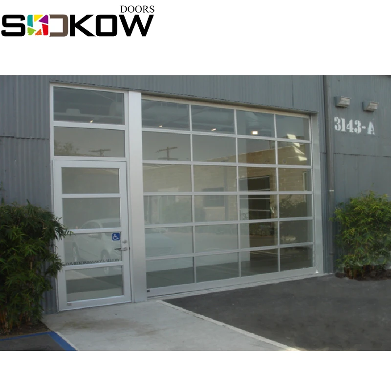 glass sectional door with pesdestrain door