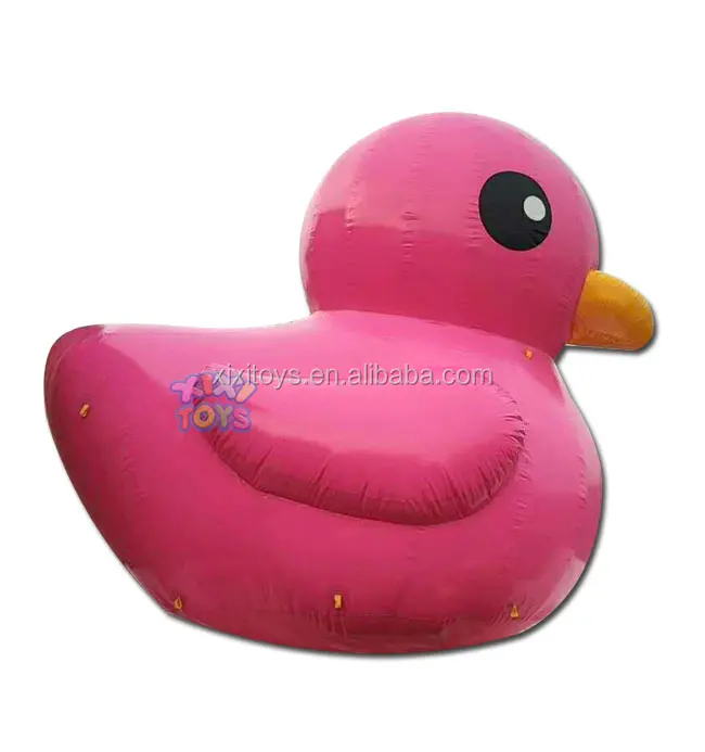 Large inflatable strawberry balloon on ground, advertising fruit inflatable character cartoon