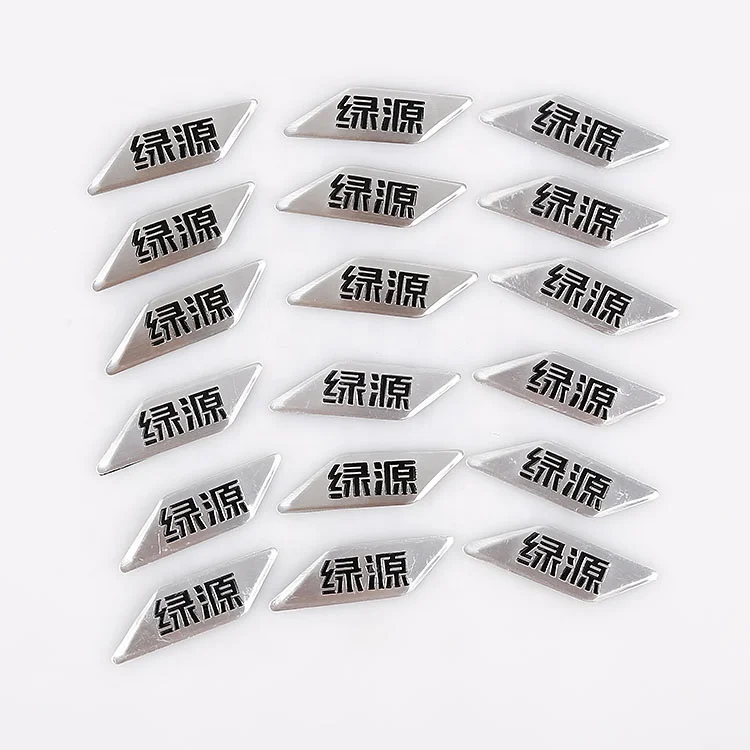 
outdoor brushed aluminum metal decal with black embossed company logo and adhesive on back 