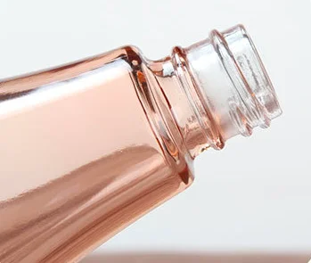 High end free sample 60ml 100ml 150ml bowling ball shape glass lotion bottle with gold pump for body face lotion