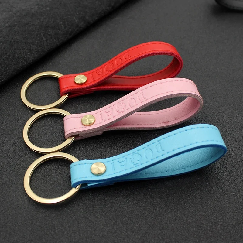 Debossed logo Promotional hanging PU or PVC leather stamped string keychain