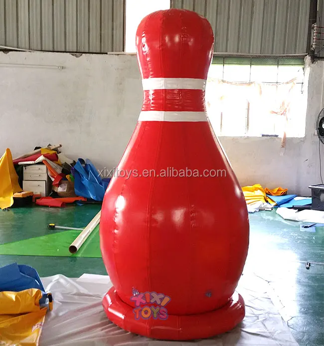Large inflatable strawberry balloon on ground, advertising fruit inflatable character cartoon