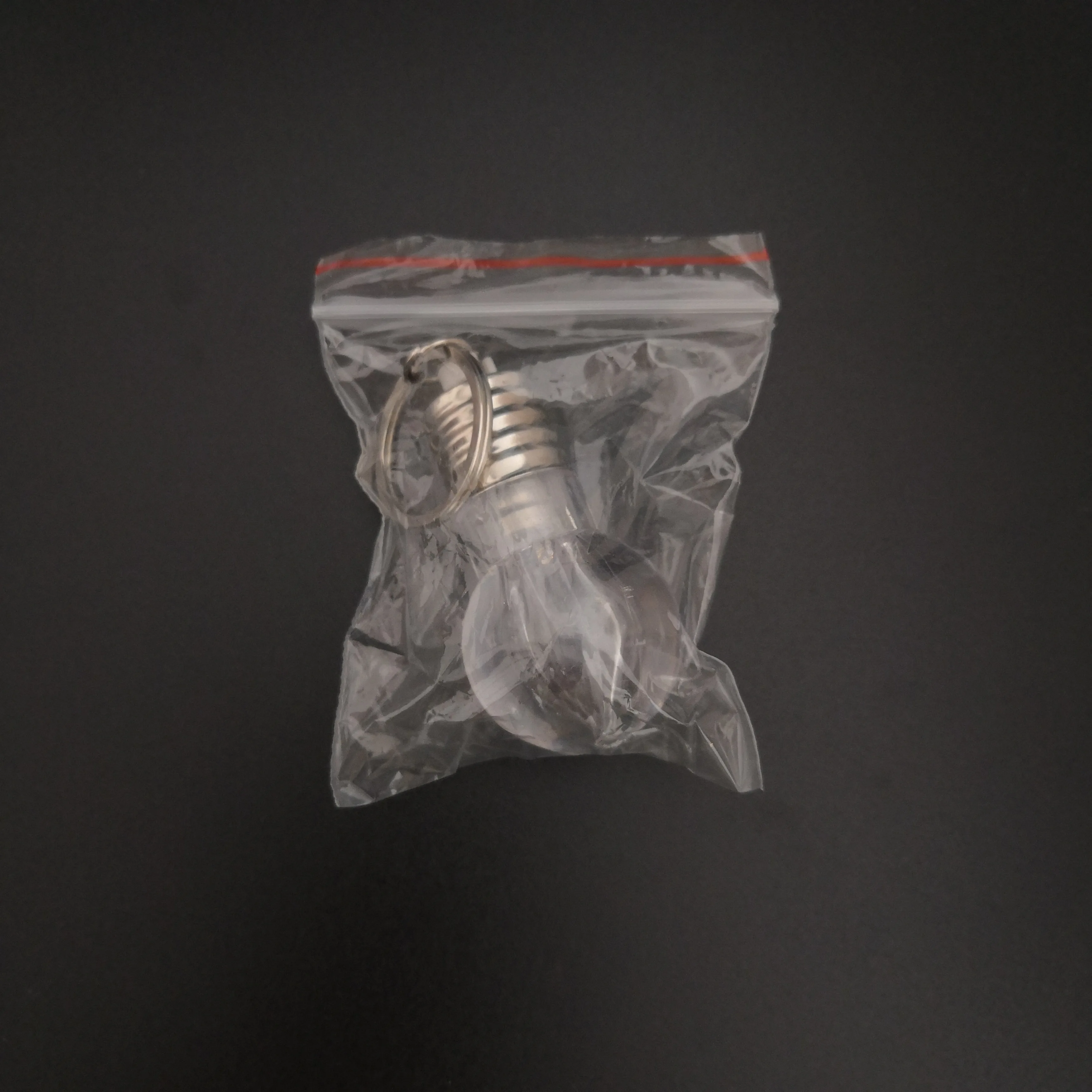 
Custom Logo Souvenir Plastic Mini Colorful Led Light Bulb Ring Keychain Cute Accesory Lovely Light Lamp Key Chain 