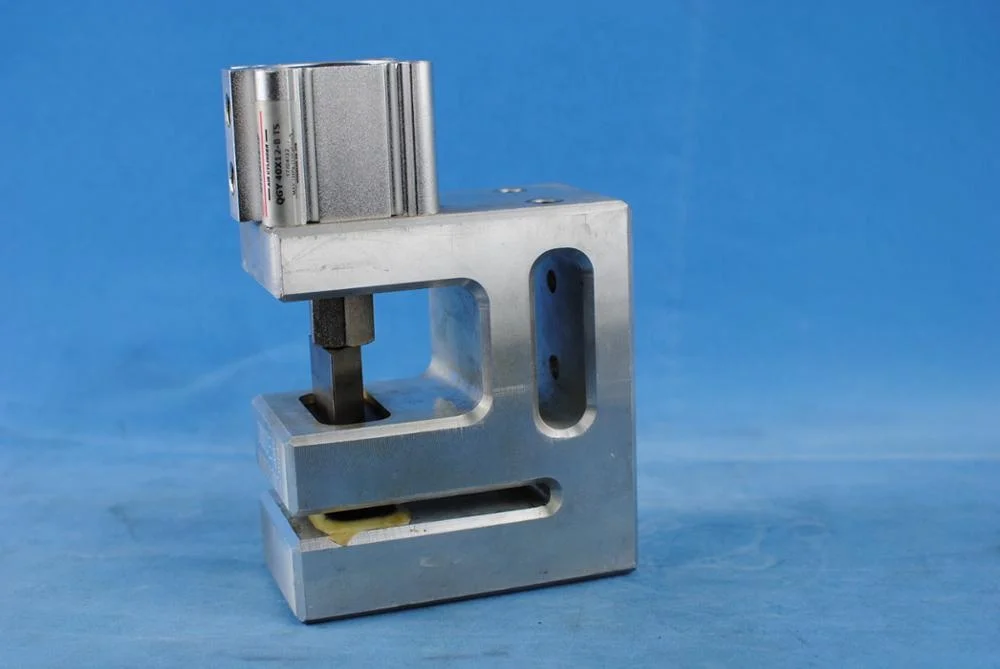 Air operated plastic bag triangle shaped hanging hole punch