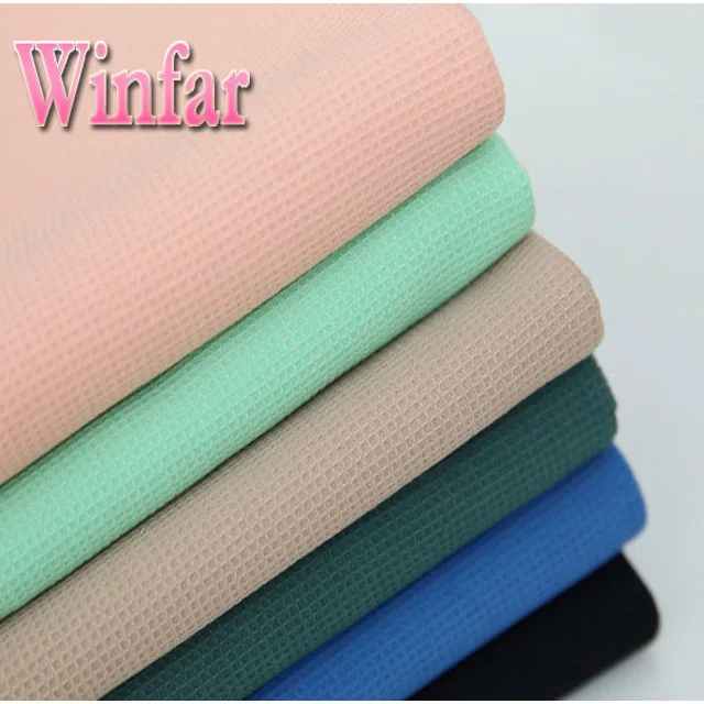 shaoxing textile polyester strong wicking solid dyed waffle fabric for bathrobe garment