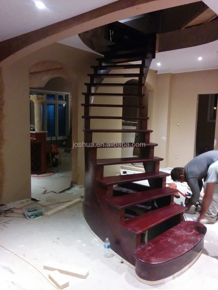 wood curved staircases with Wrought-iron balusters