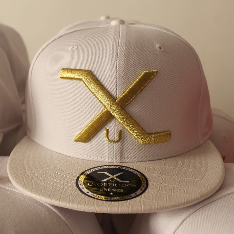Acrylic leather brim snapback cap with gold metallic thread embroidery