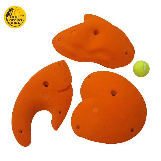 Adult climbers climb rock climbing holds jugs for indoor