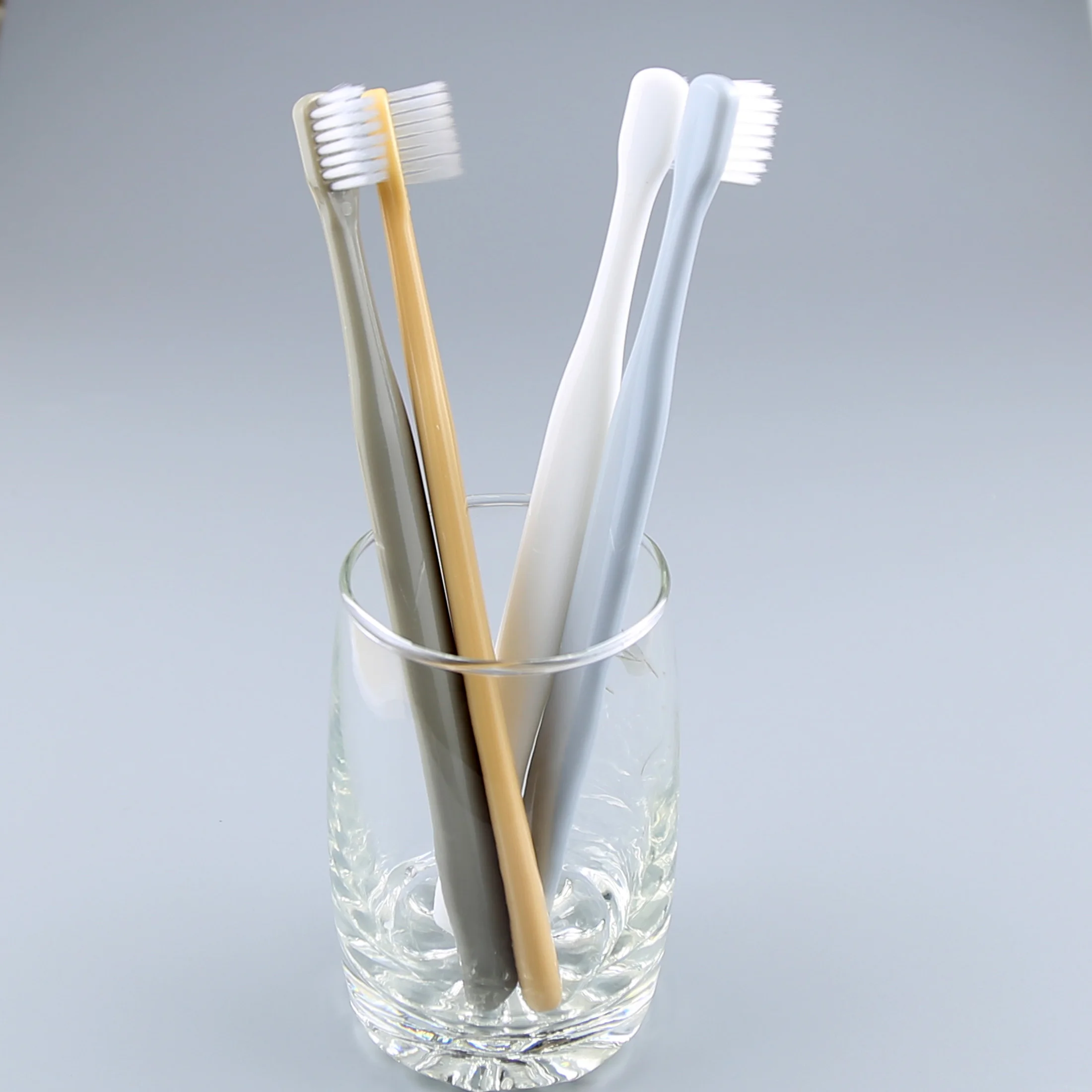 popular design small head toothbrush with super soft bristles in PVC transparent box package.