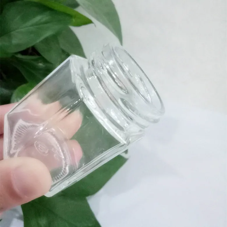 Wholesale different sizes hexagon honey glass jar glass storage bottle with black screw metal lid