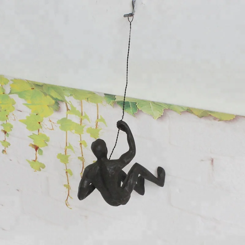 Rock climb with rope Muscular man bronze sculpture