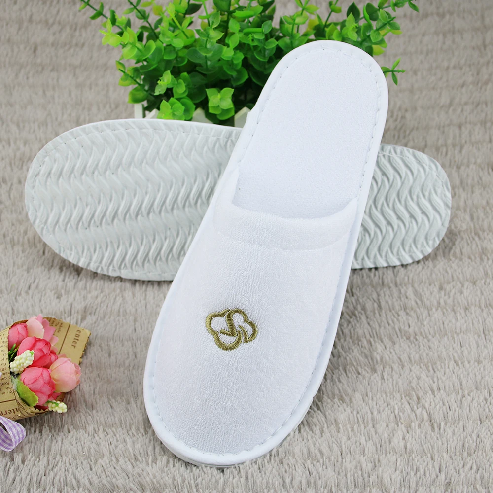 
white terry disposable hotel bathroom slippers 