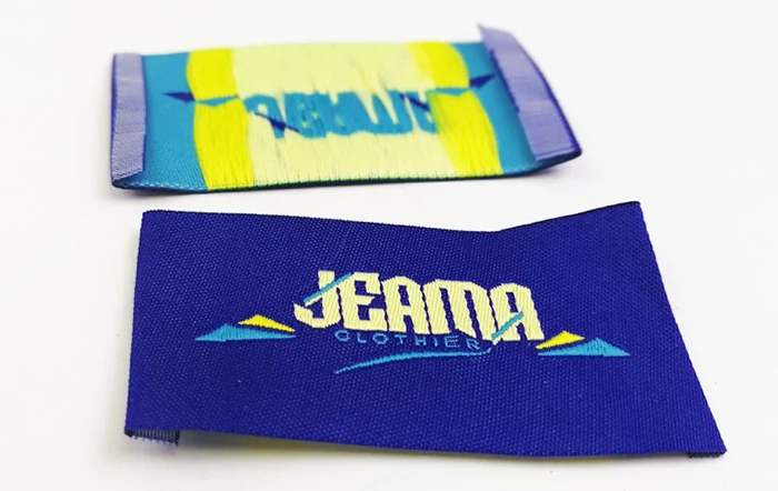 High density gold thread woven label with fold