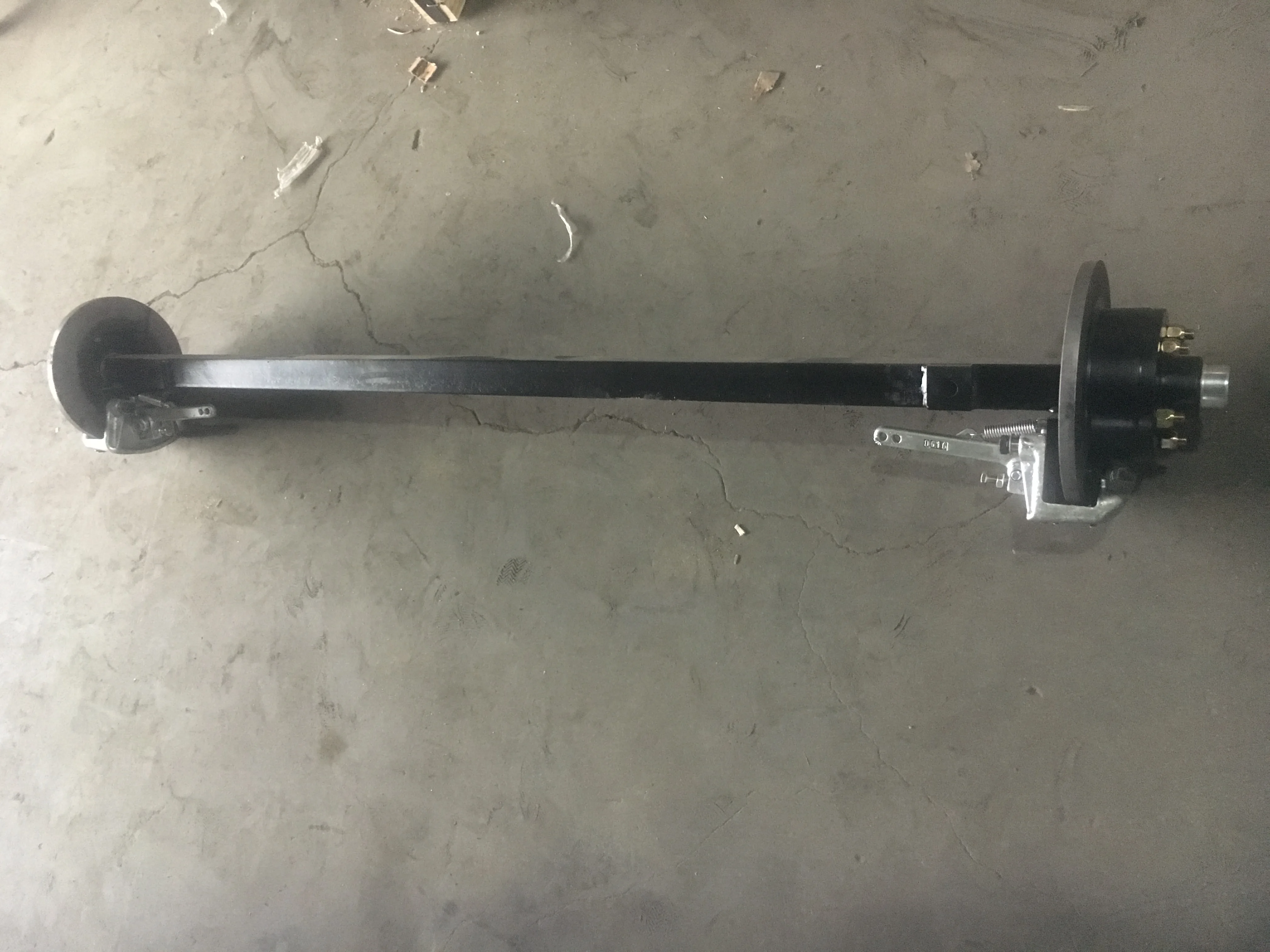 Axle for trailers with hand breaker