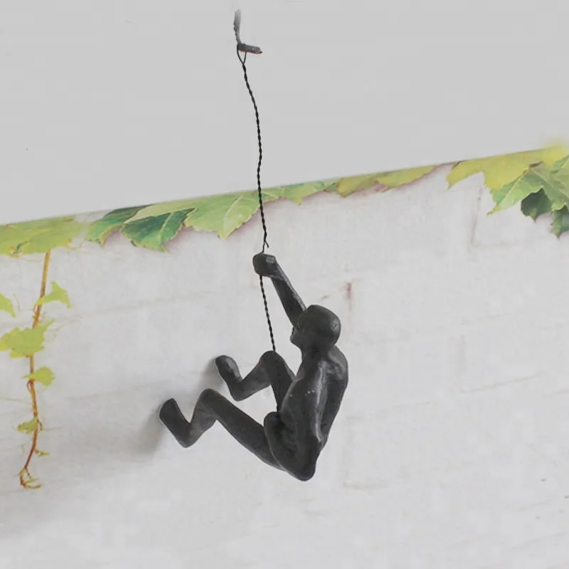 Rock climb with rope Muscular man bronze sculpture