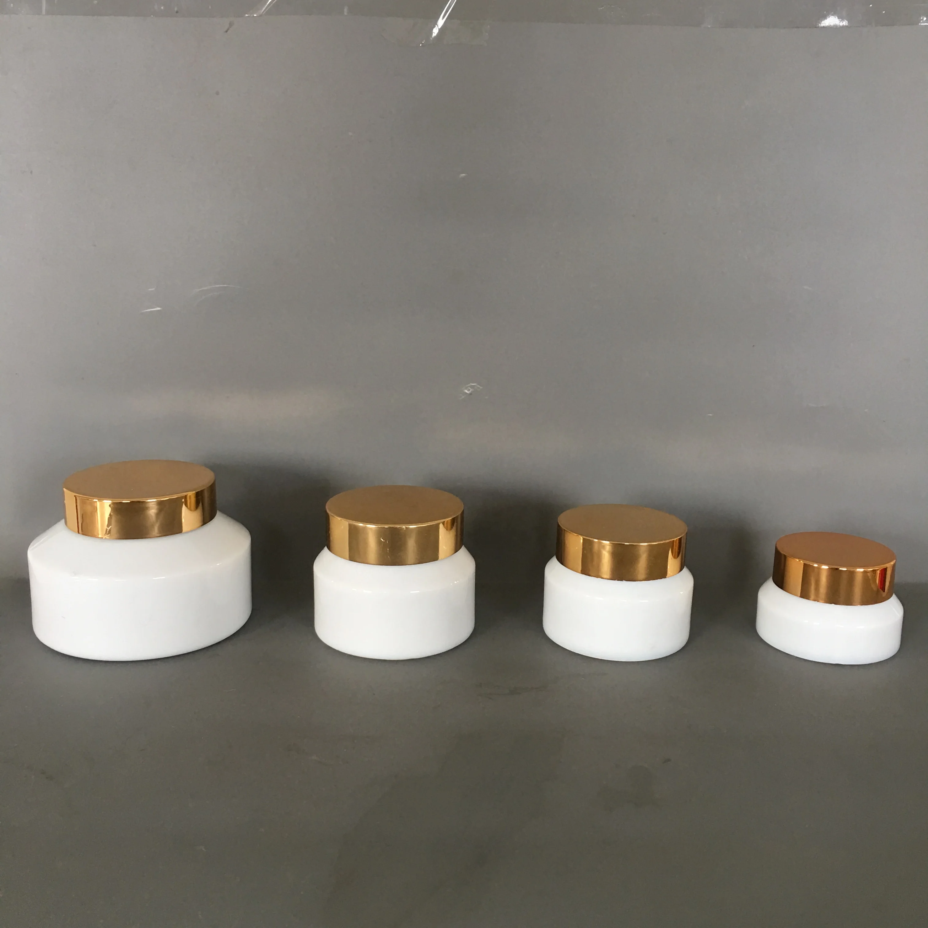 Cosmetic packaging slant shoulder white glass bottle and jar series with gold lid/pump/dropper cosmetic lotion bottle products