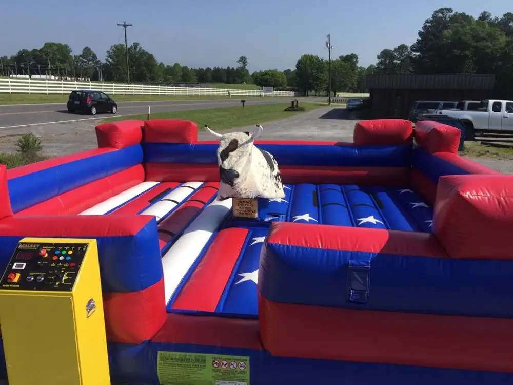Giant Mechanical Rodeo Bull With Inflatable Mattress Interactive Game In Amusement Park