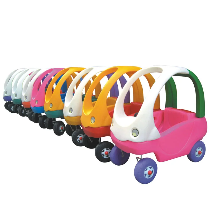 
Kindergarten school children play toy ride on car for kids in India 