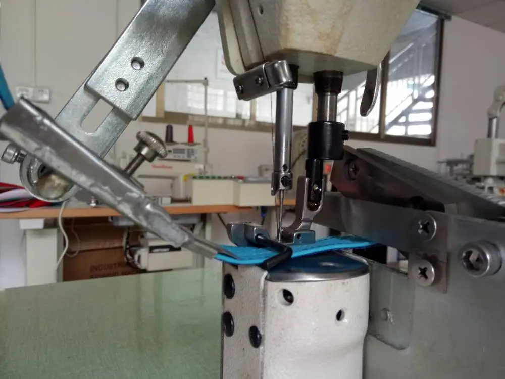 High post bed sewing machine with a folder and cutting device for sweatband