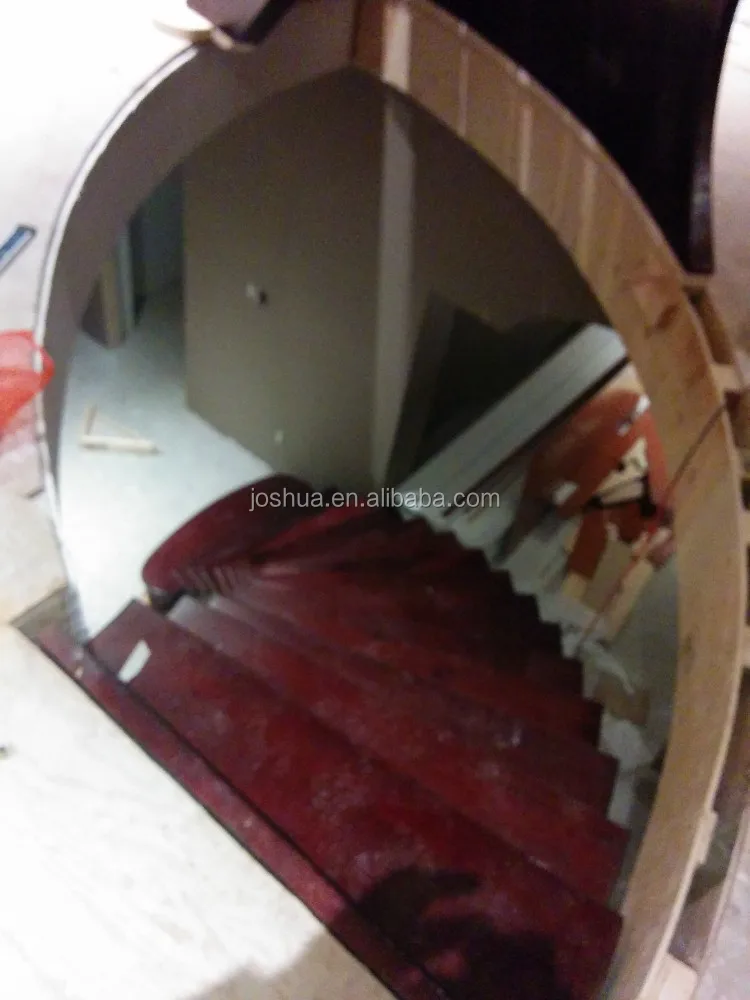 wood curved staircases with Wrought-iron balusters