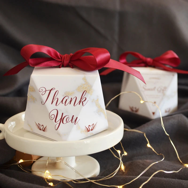 
Retail white diamond style folding candy boxes with red ribbon 