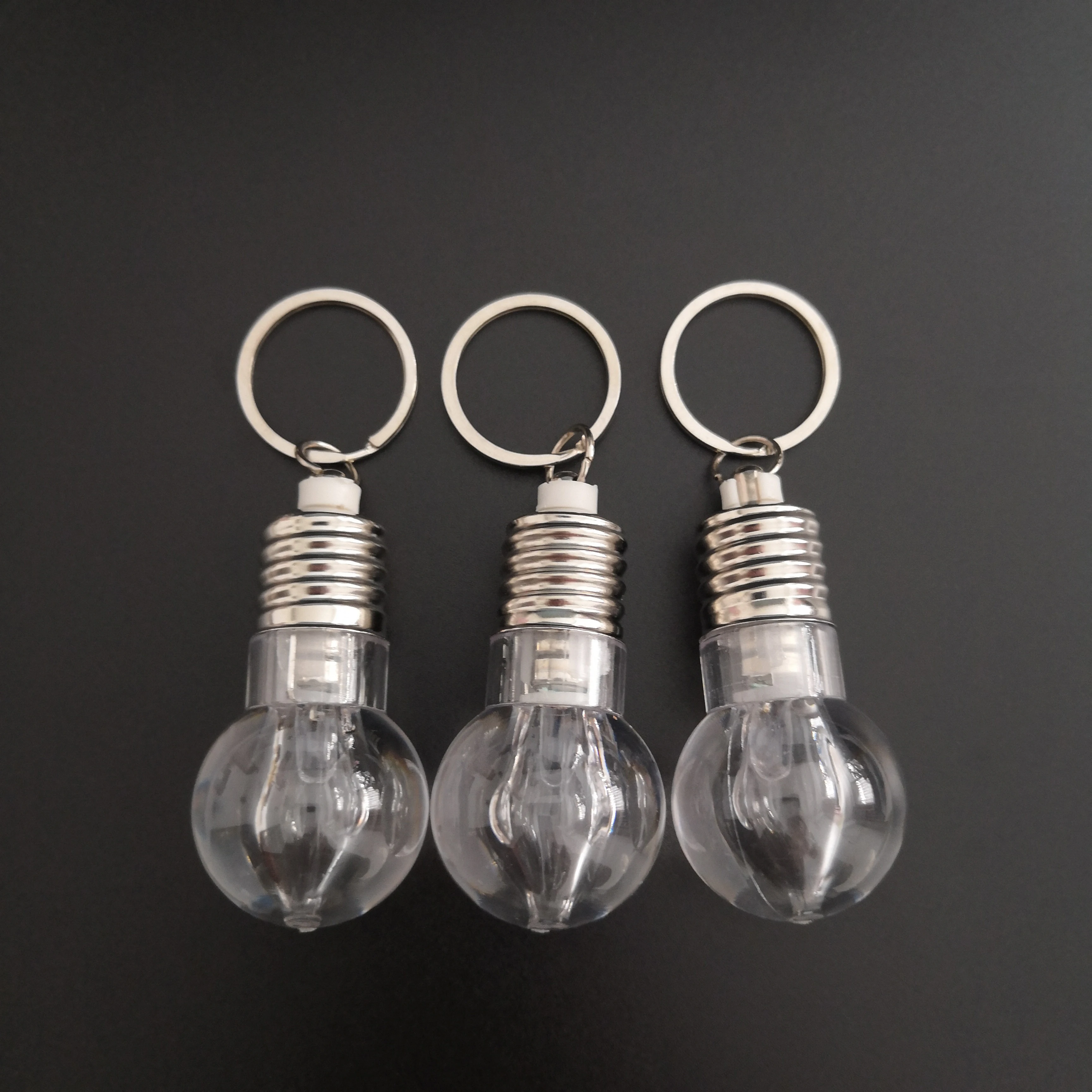 
Custom Logo Souvenir Plastic Mini Colorful Led Light Bulb Ring Keychain Cute Accesory Lovely Light Lamp Key Chain 