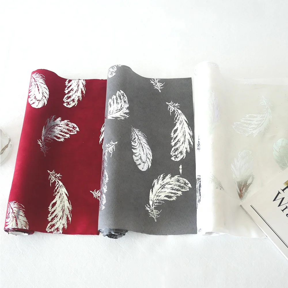 
Suede table runner,bronzed feather design 