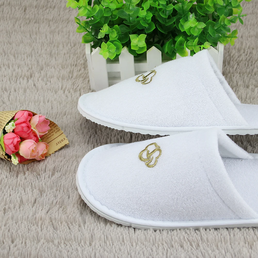 
white terry disposable hotel bathroom slippers 