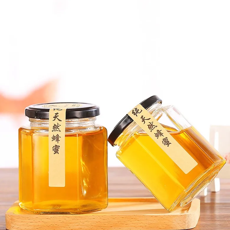 Wholesale different sizes hexagon honey glass jar glass storage bottle with black screw metal lid