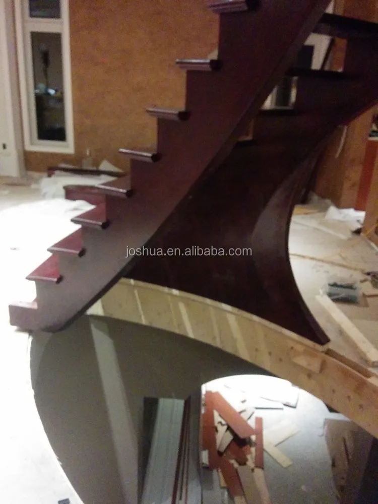 wood curved staircases with Wrought-iron balusters