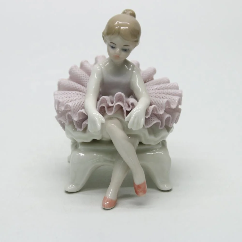Ceramic ballerina dancer girl figurines on the chair