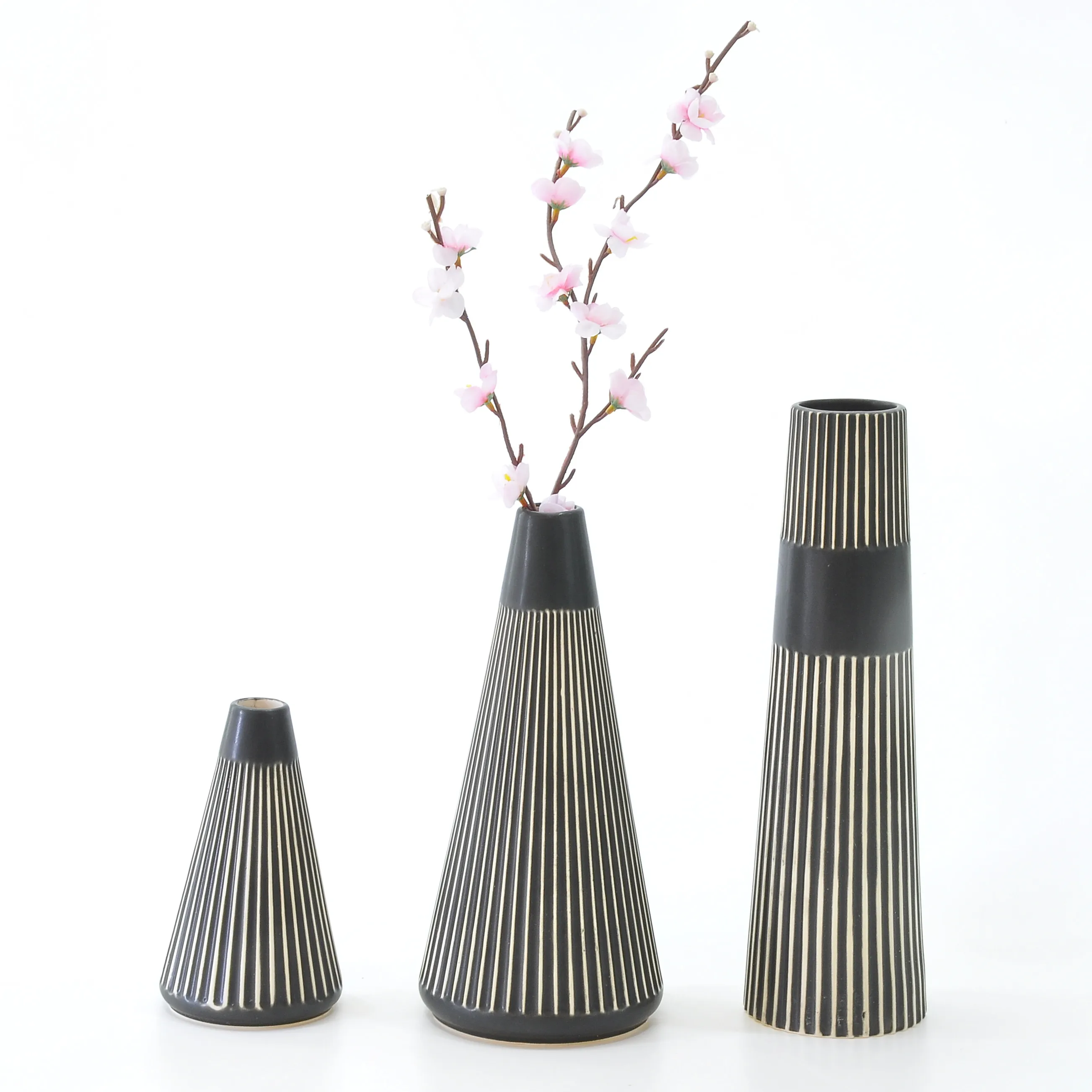 Modern decorative slim ceramic vases with flowers in glaze with rubbing