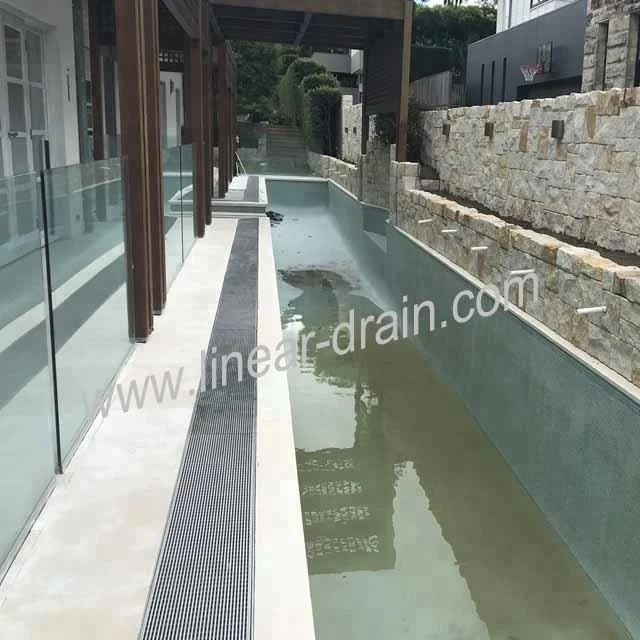 
beautiful swimming pool water draining gutter 
