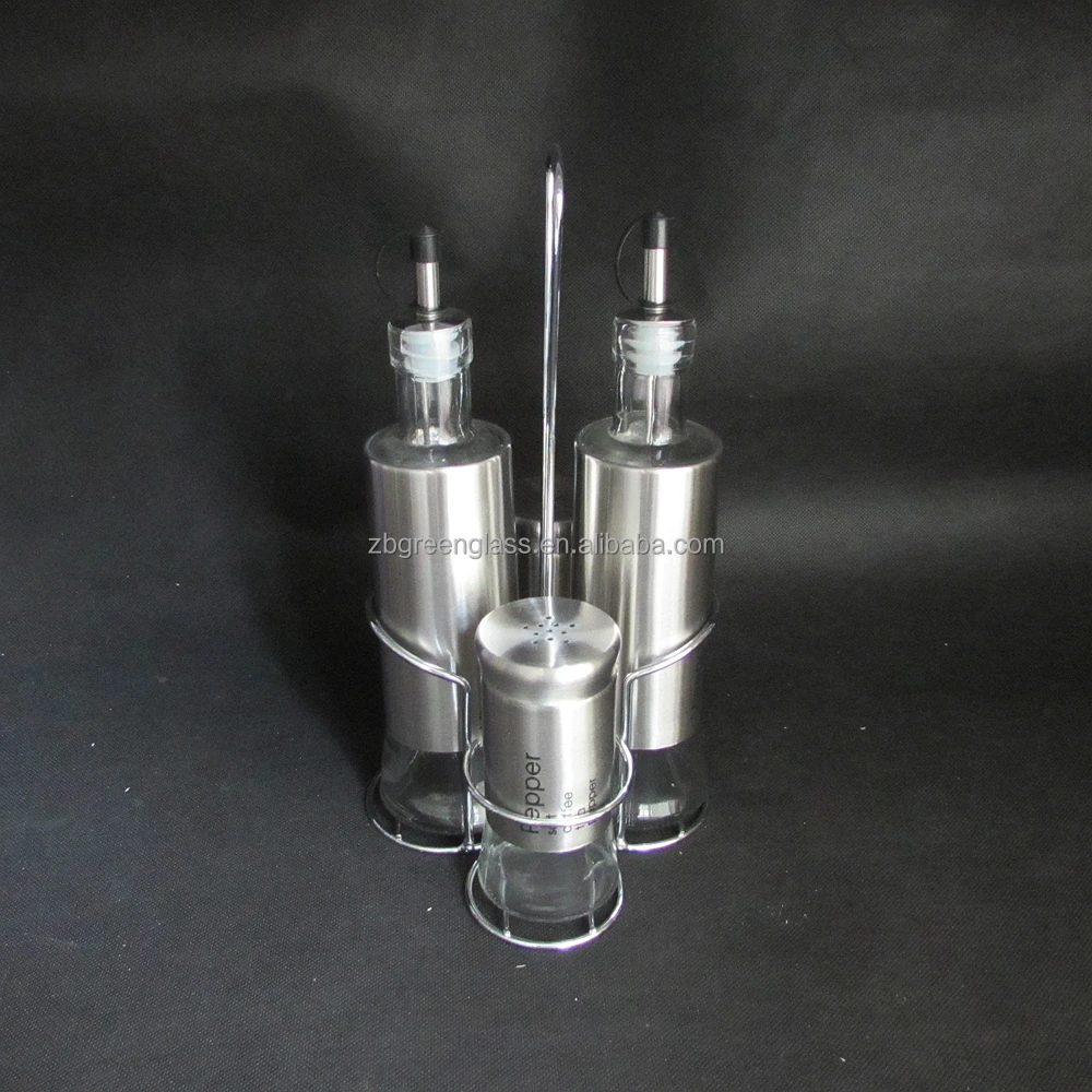 Glass salt pepper shakers and oil vinegar bottles with metal stand