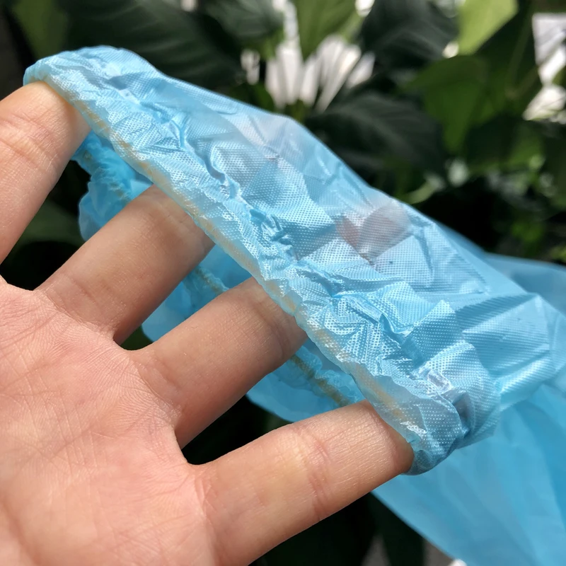 Blue & White disposable waterproof Plastic patient cpe gown with rubber rolled cuff Available in standard and reinforced