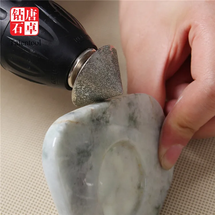 A diamond-encrusted diamond bit used for grinding and sculpting stone glass tiles