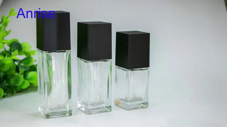 Distinctuve 30ml 50ml Square Clear Glass Cosmetic Essence Bottle Refillable Serum Squeeze Spray Bottle with Black Cube Cap