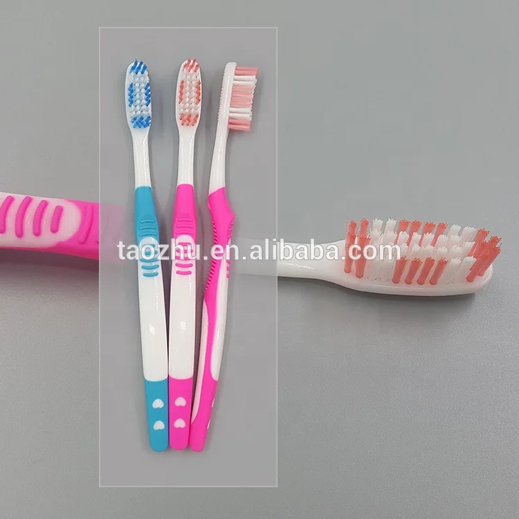 Hard rubber grip adults toothbrush with medium or soft, hard nylon bristle