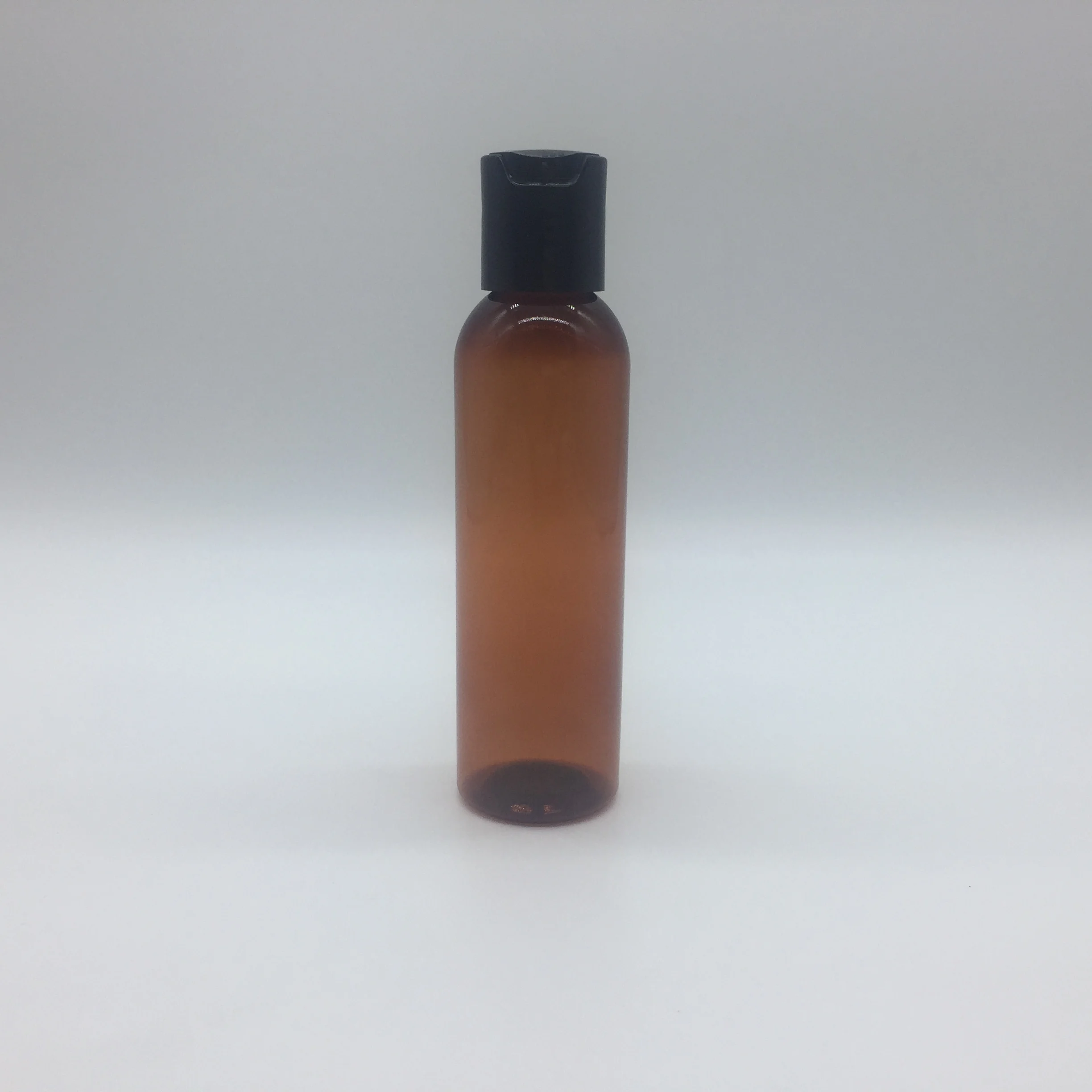 
4OZ amber cosmo round PET bottle with disc top cap 