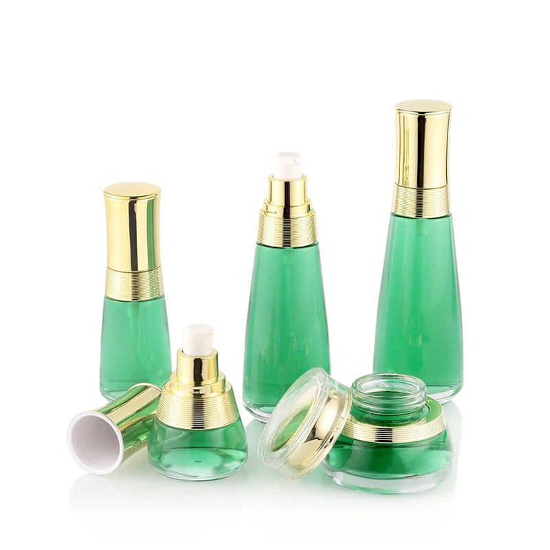 Custom cosmetic packaging transparent skin care glass bottle set with gold cap