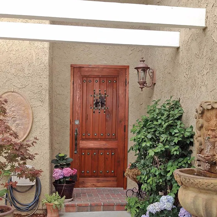 Traditional old castle wood door with wrought iron grill and clavos